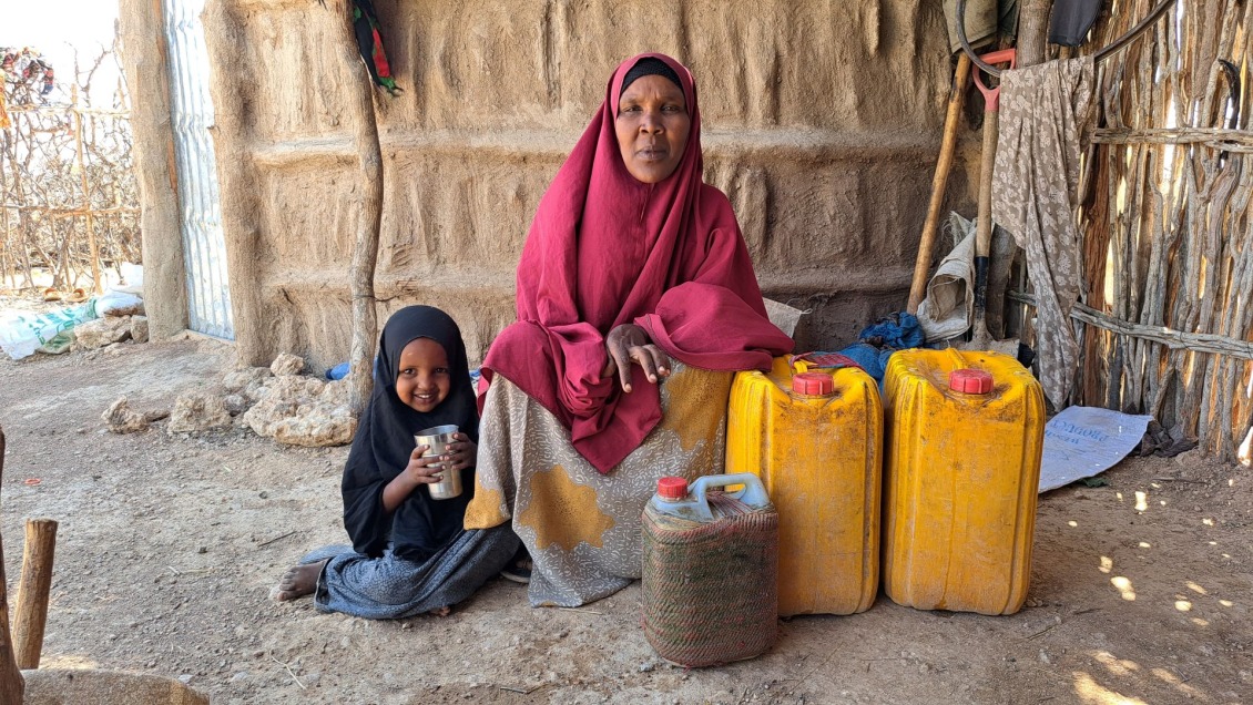 Salaado and her children with jerry cans of clean water.