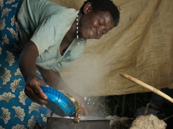 Sophia cooking for her family at home in Kanyeti village in Kasese, Uganda.