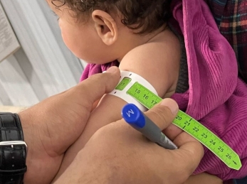A child is screened for malnutrition in Gaza in April 2025.