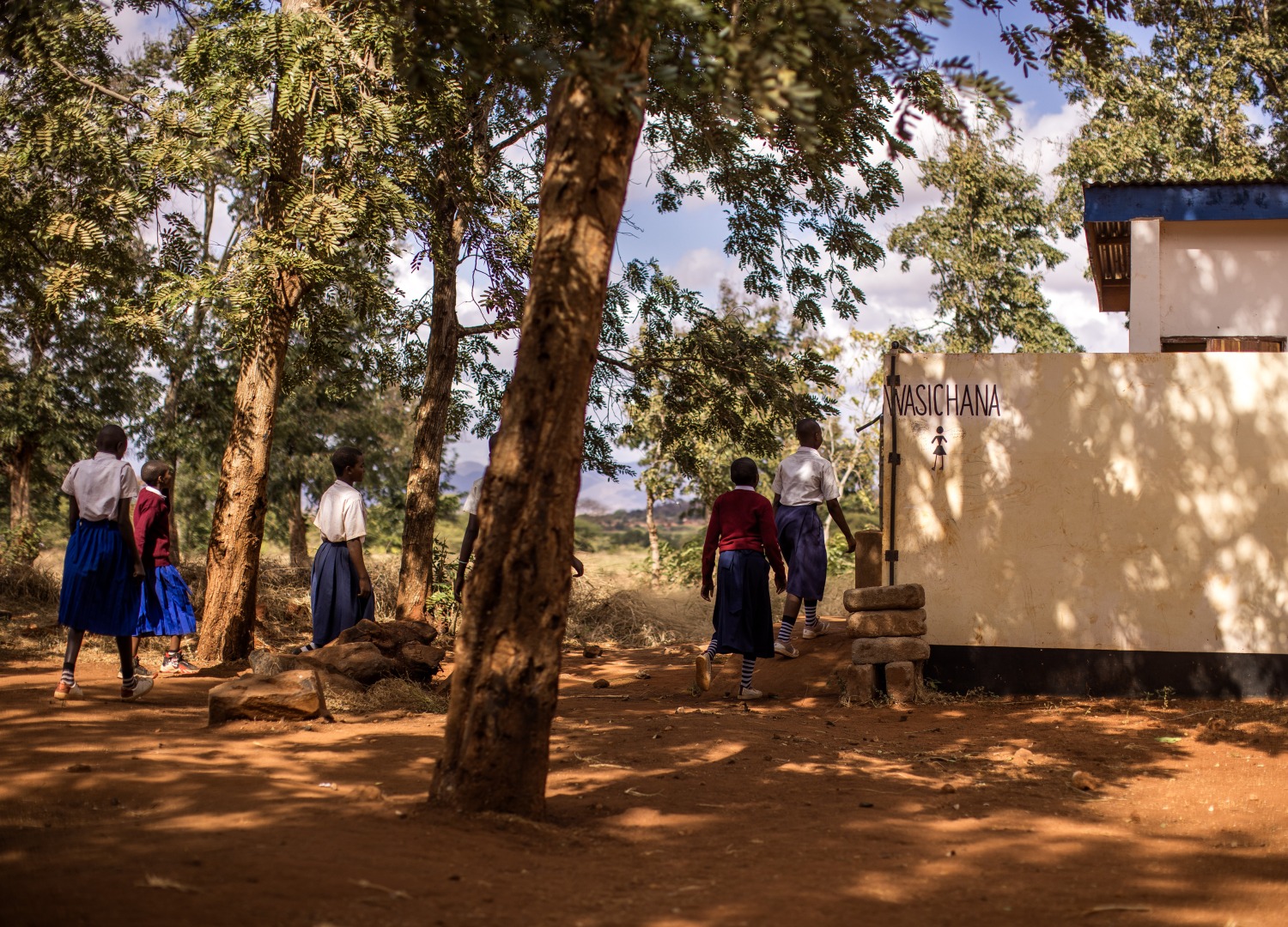 Girls access the bathrooms built by Action Against Hunger at their school in Tanzania
