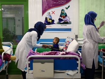 Nurses interact with acutely malnourished infants and their mothers in an inpatient ward at Action Against Hunger’s therapeutic feeding unit in Kabul’s Ahmad Shah Baba Mina area on April 15, 2023.