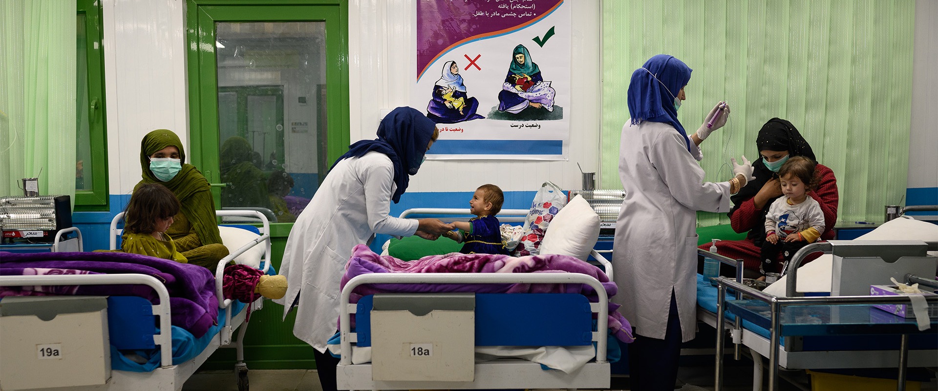Nurses interact with acutely malnourished infants and their mothers in an inpatient ward at Action Against Hunger’s therapeutic feeding unit in Kabul’s Ahmad Shah Baba Mina area on April 15, 2023.