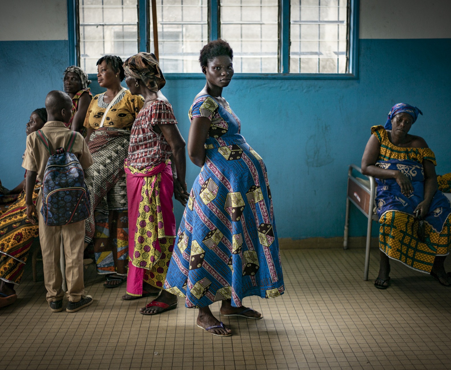 A pregnant woman waits inside a health center in Bacabo, Ivory Coast.