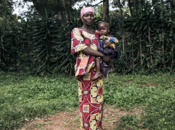 Georgine Dz'dha Nzale holds her 27-month-old son, David Wauba, who suffers from severe acute malnutrition, near the Drodro Health Center in Ituri, northeastern Democratic Republic of Congo.