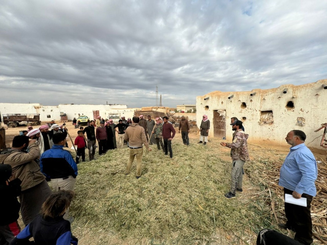 Farmers gather outside of Ibrahim