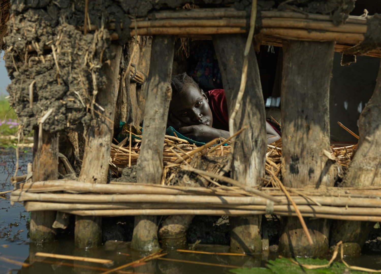 A woman in a house that is flooded in South Sudan