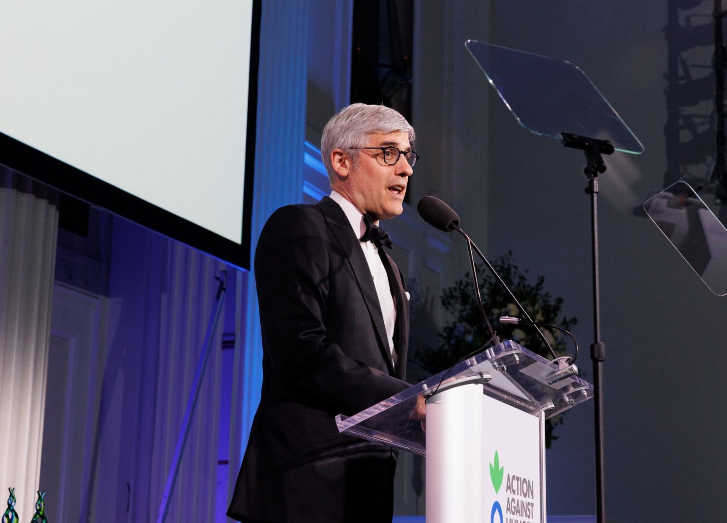 Mo Rocca speaking at Action Against Hunger's 2024 gala