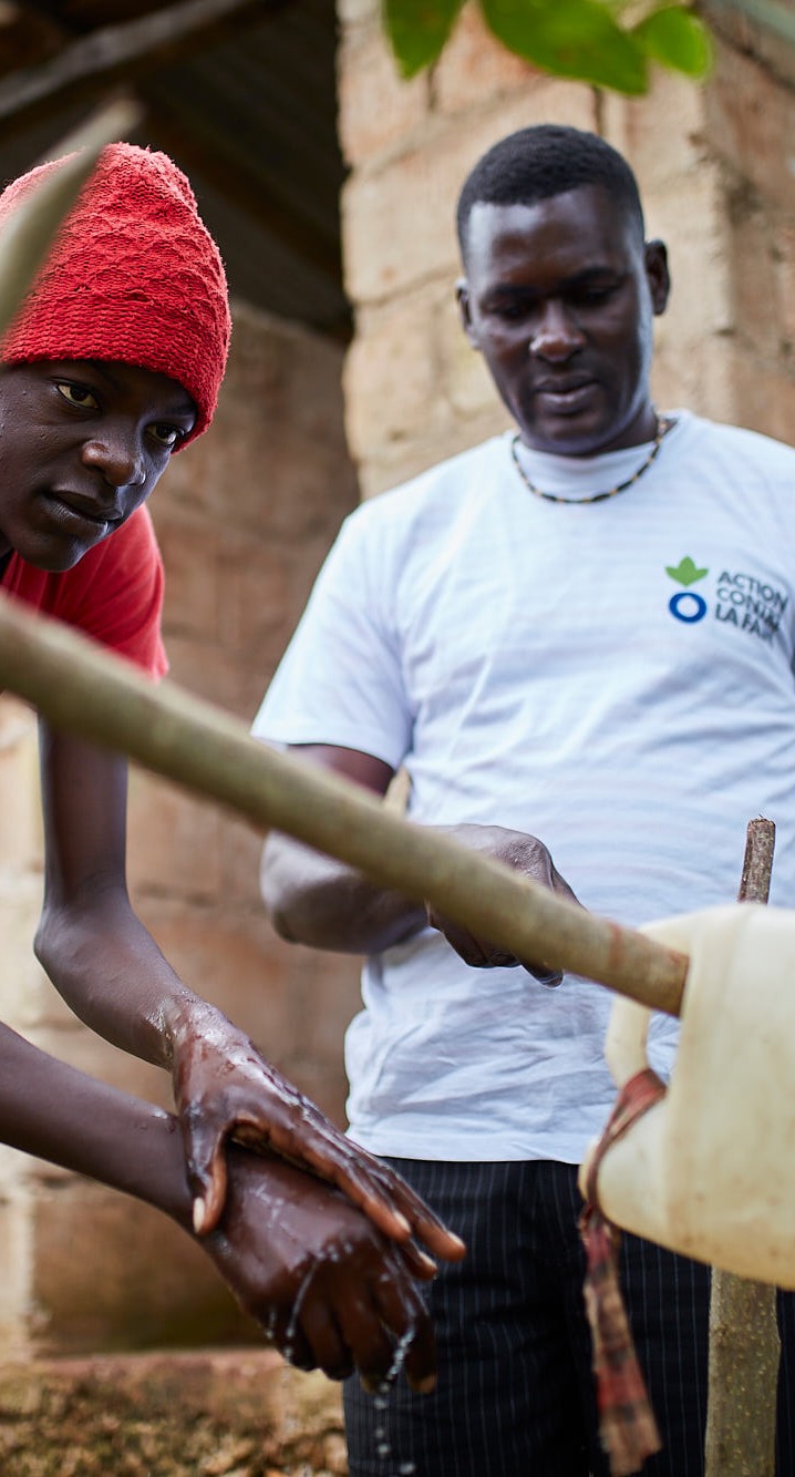 Action Against Hunger teams carry out sensitization activities with families to teach about good hygiene and encourage use of latrines.