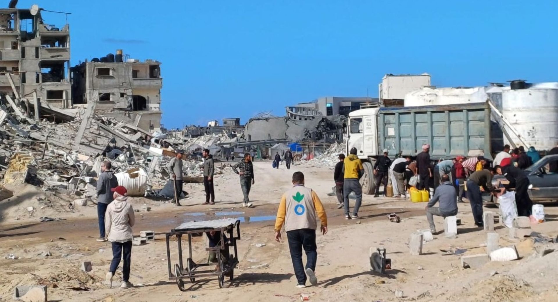 Action Against Hunger aid worker walking amidst rubble in Gaza in January 2025.