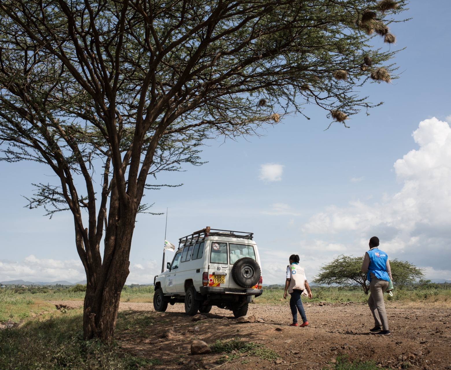 An Action Against Hunger truck in a field