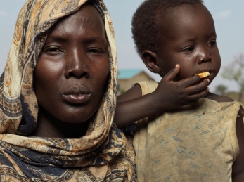 A woman with a child in South Sudan.