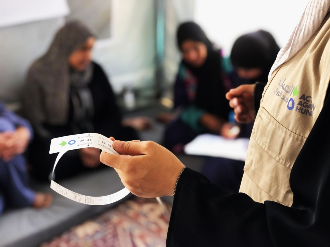 A MUAC band helps mothers spot malnutrition early.