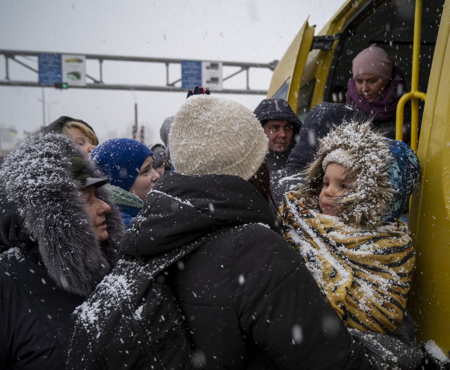 Ukrainian refugees face winter weather as they board a bus and cross the border into Moldova.