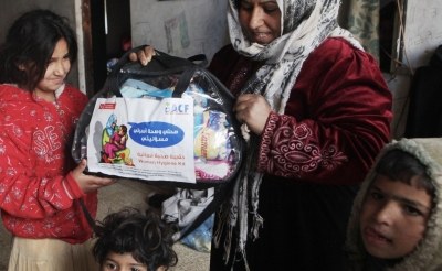 A family receives an emergency kit from Action Against Hunger