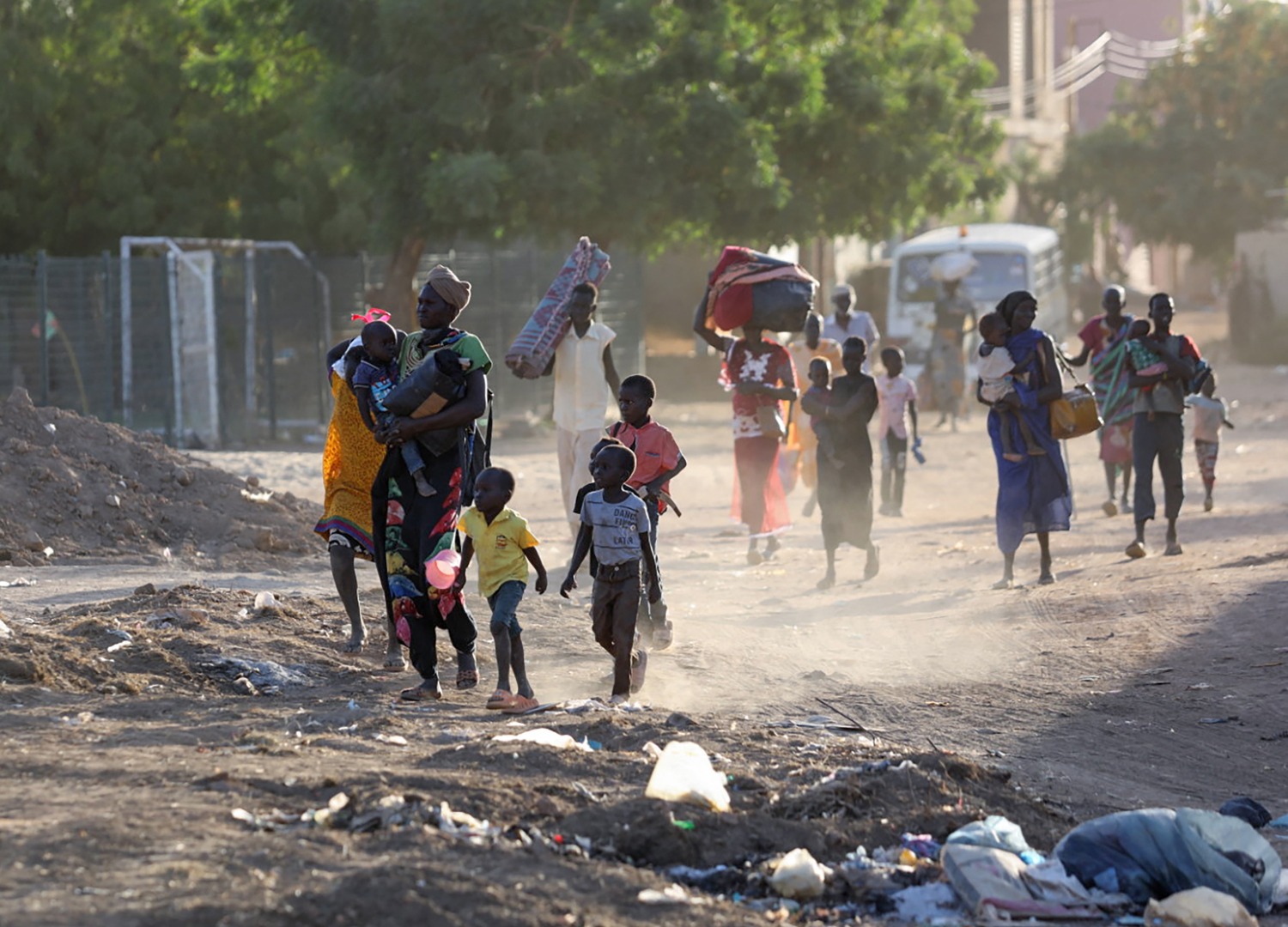 People flee their neighborhoods amid fighting between the army and paramilitaries in Khartoum on April 19, 2023, following the collapse of a 24-hour truce.