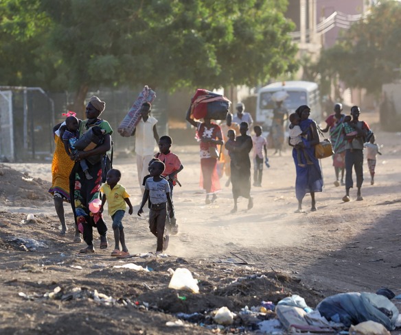 People flee their neighborhoods amid fighting between the army and paramilitaries in Khartoum on April 19, 2023, following the collapse of a 24-hour truce.