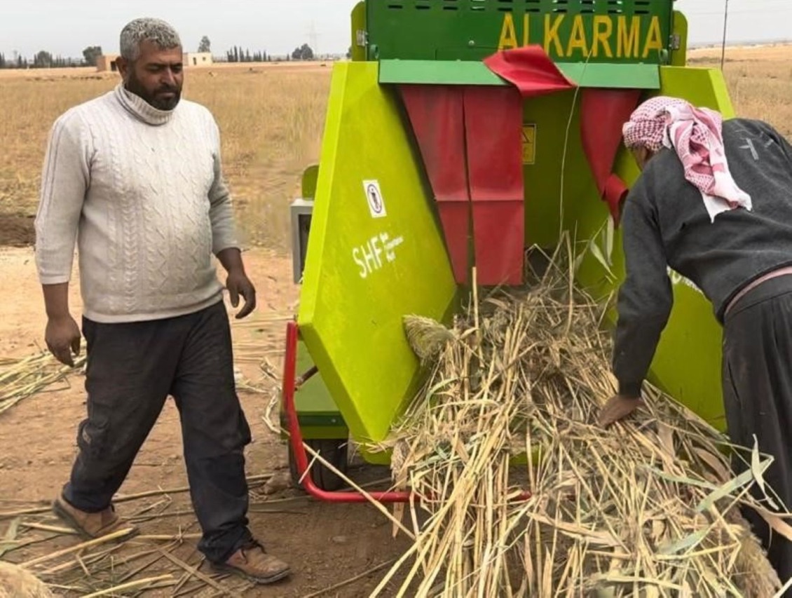 Ibrahim using the grinder provided by Action Against Hunger.