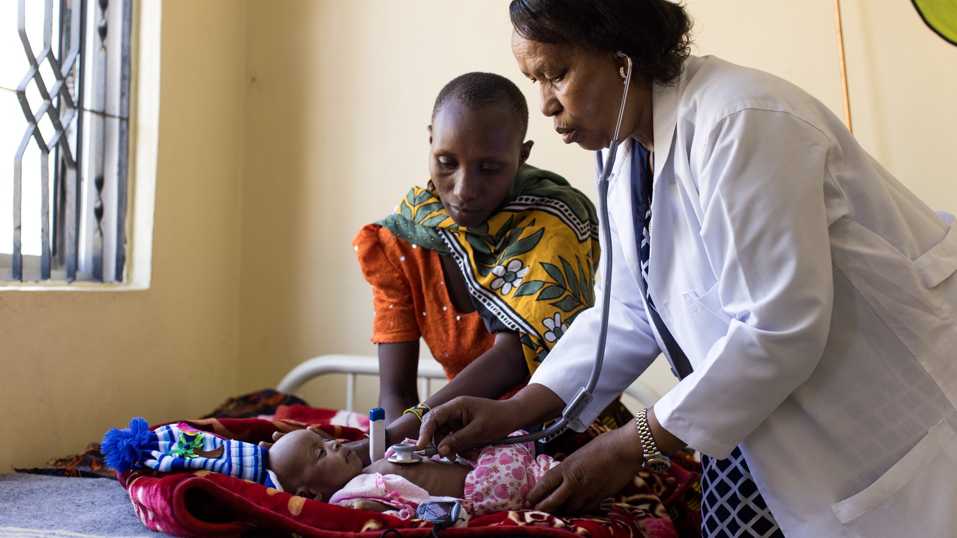A doctor examines a child in a health center