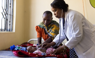 A doctor examines a child in a health center